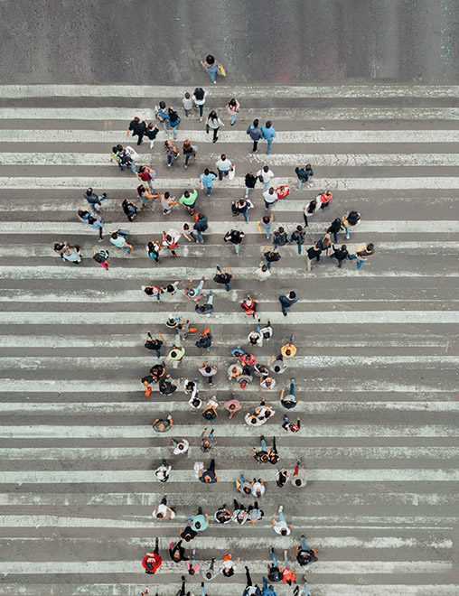 diverse group of people crossing an intersection